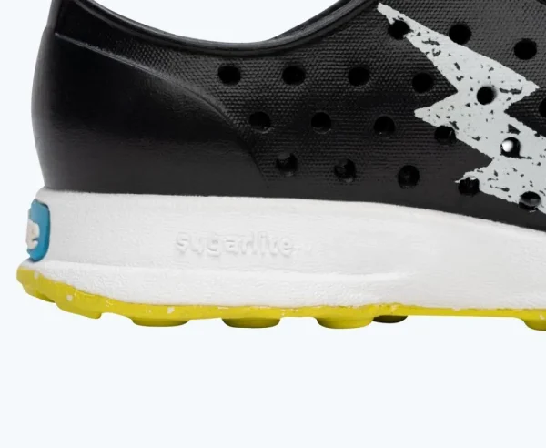 Native Shoes Shoes^Robbie Sugarlite Glow Child Jiffy Black/ Shell White/ Shell Lightning Glow/ Pickle Speckle Rubber